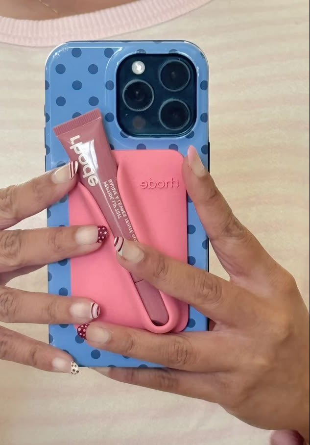 Blue polka dot phone case with pink card holder and wrist strap