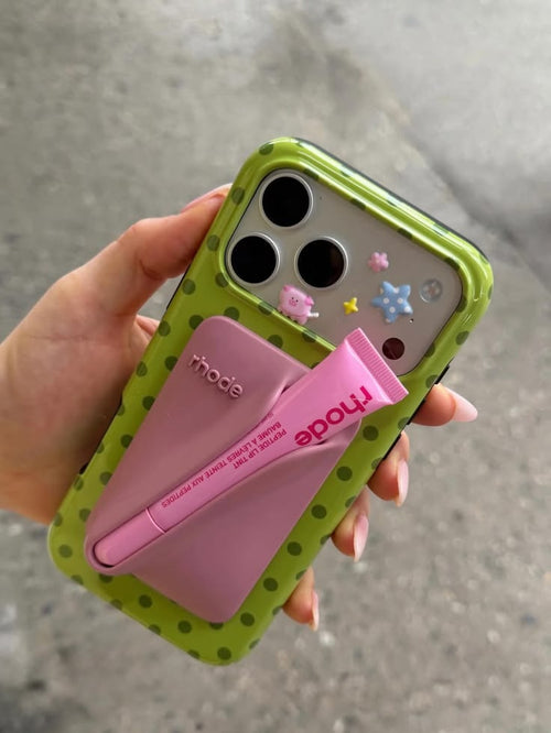 Lime green polka dot phone case with pink card holder and camera cutouts