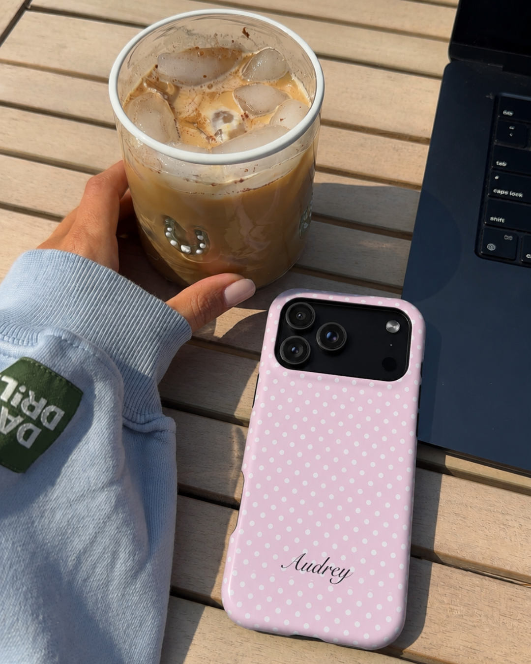 Pink polka dot phone case with cursive 'Audrey', camera openings visible
