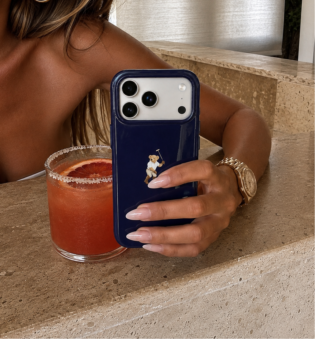 Navy blue phone case with teddy bear graphic and cutouts for dual rear cameras.