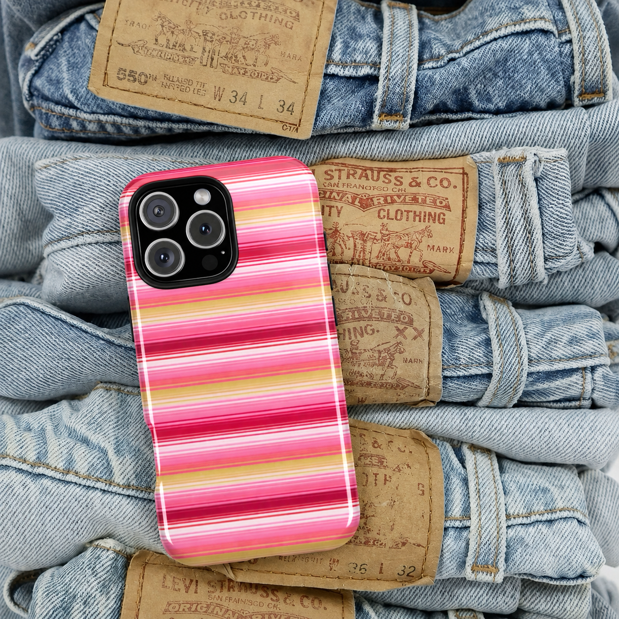 Pink and yellow striped phone case with raised edges and four-camera cutout
