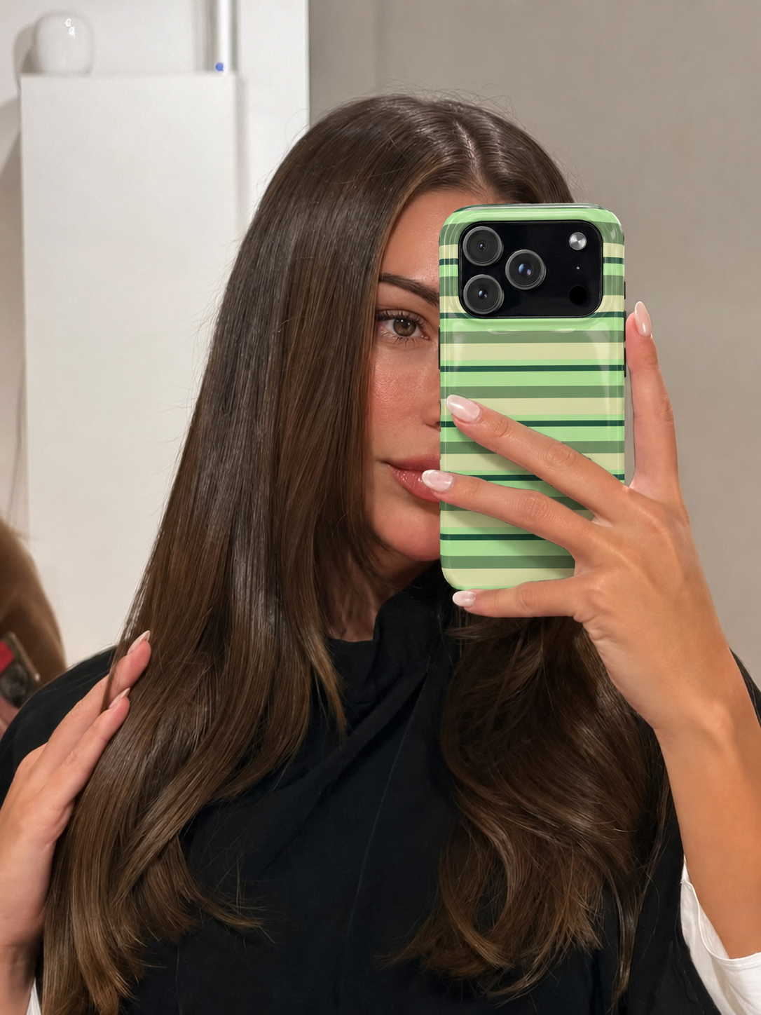 Green striped phone case with cutouts for dual cameras and flash