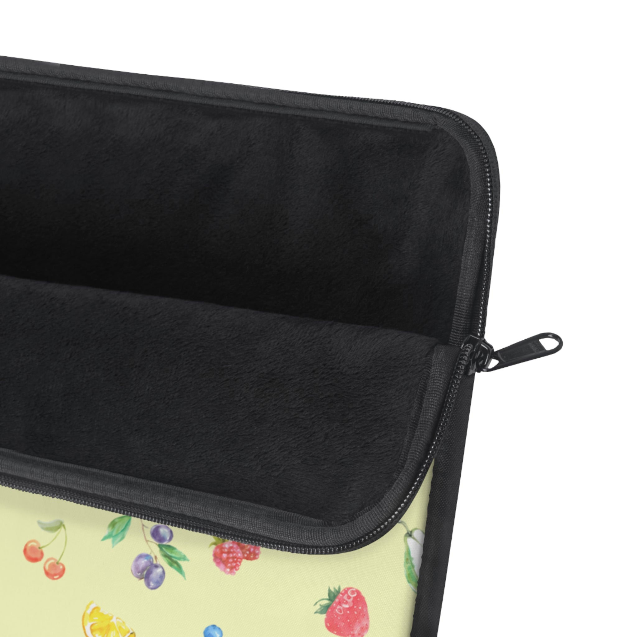 Neoprene sleeve with black zipper edge and fruit-print yellow outer fabric