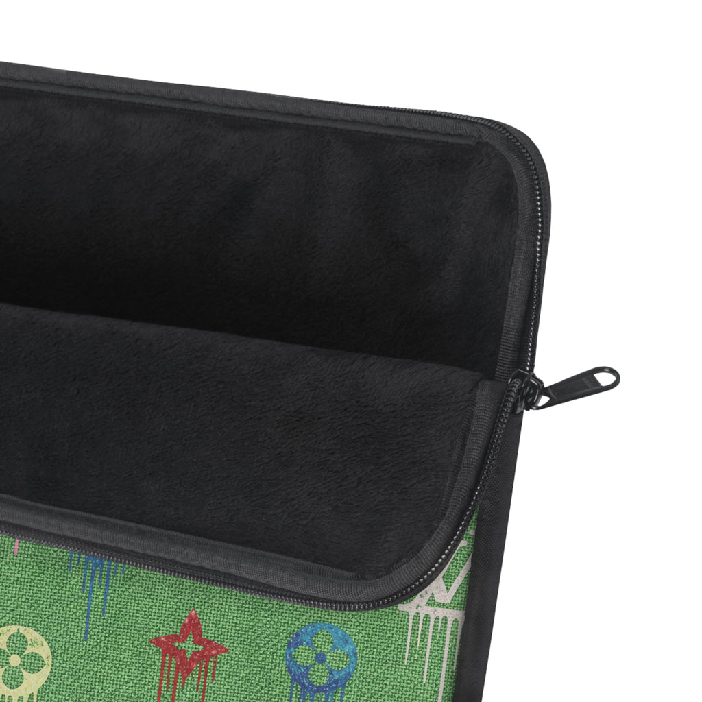 Black-lined tech sleeve with black zipper and green patterned exterior