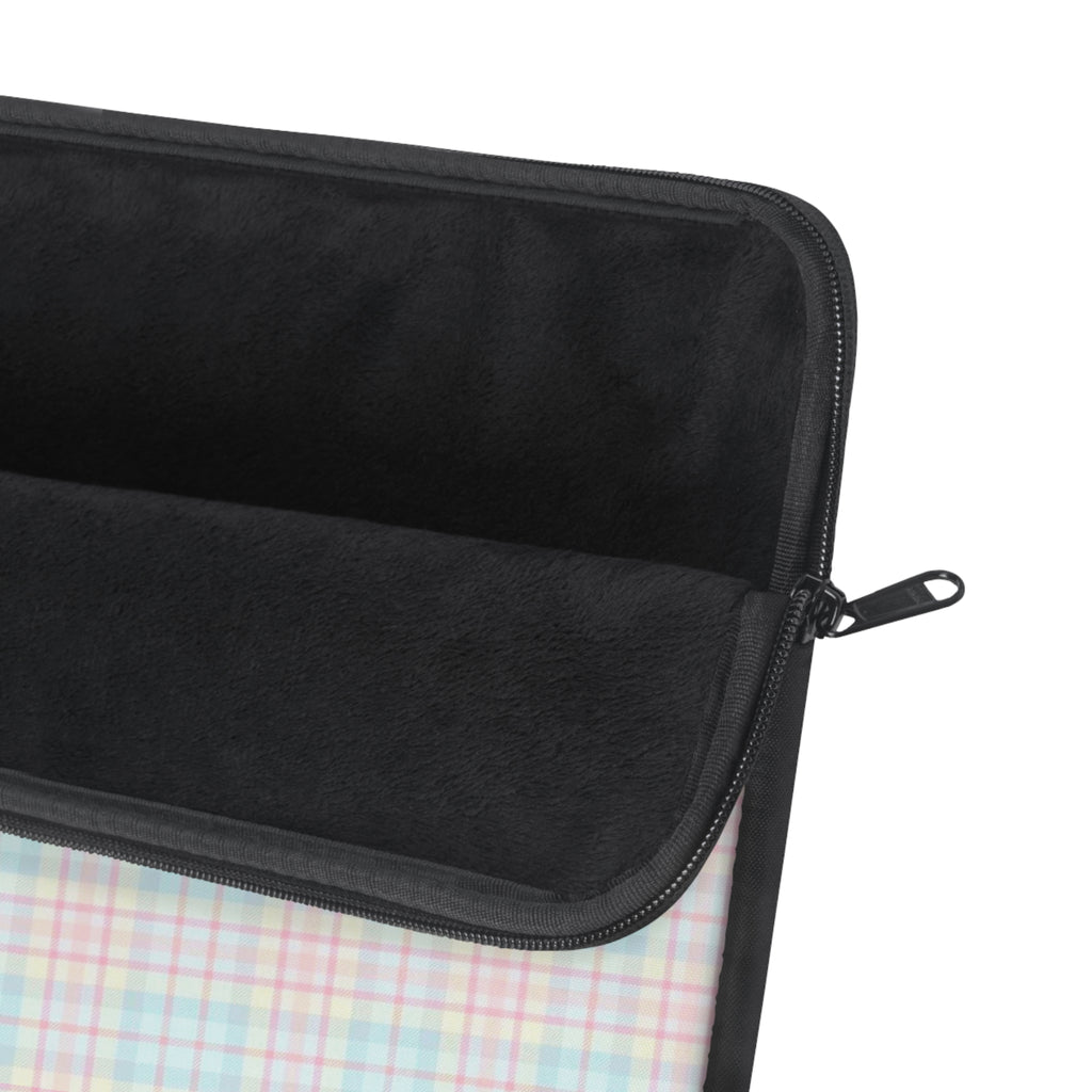 Black fabric device sleeve with zip closure and handle pull; plaid lining visible.