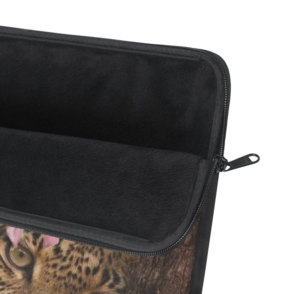 Black laptop sleeve with zippered edge and zipper pull, partial cheetah graphic
