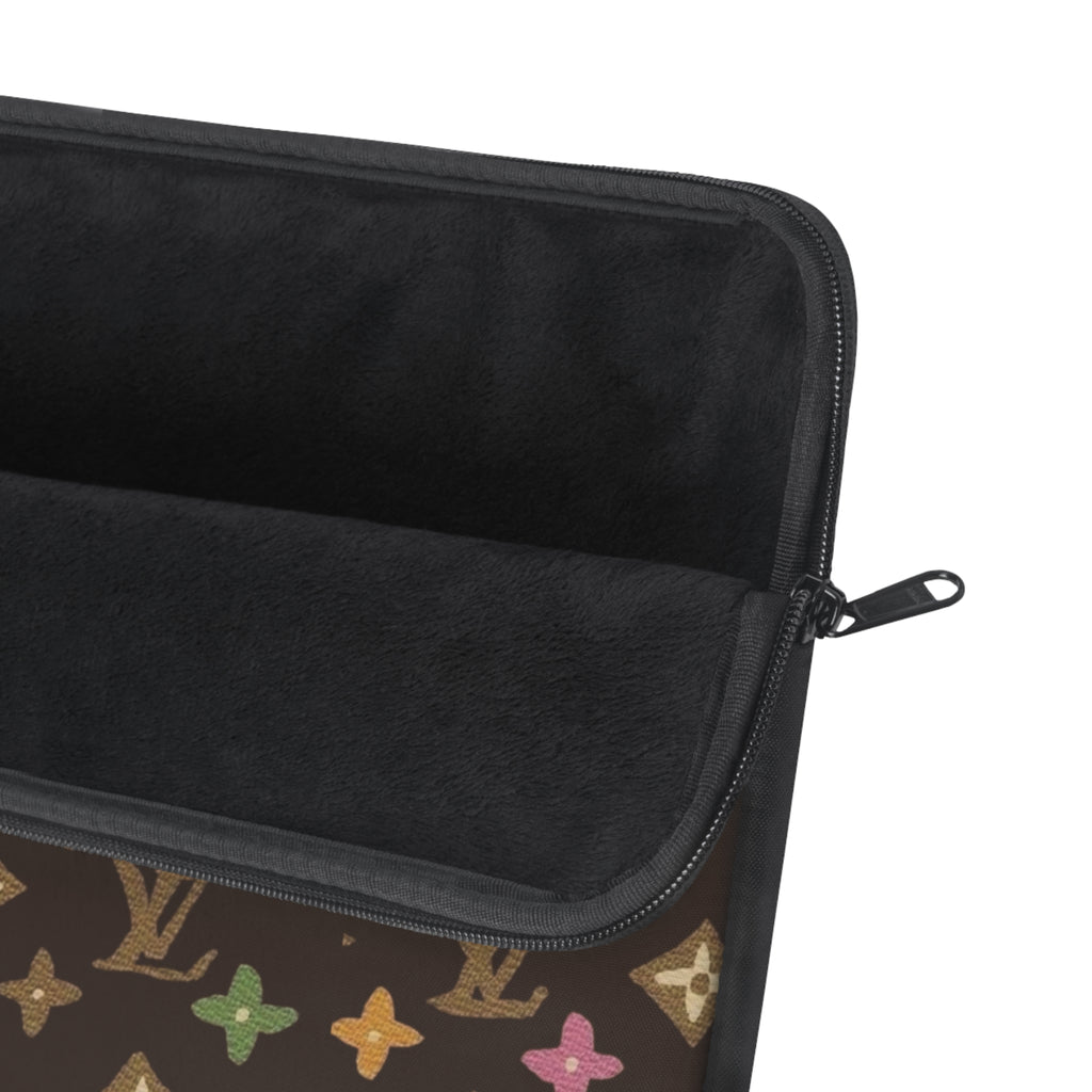 Zippered laptop sleeve with black interior lining and multicolor monogram side panel.
