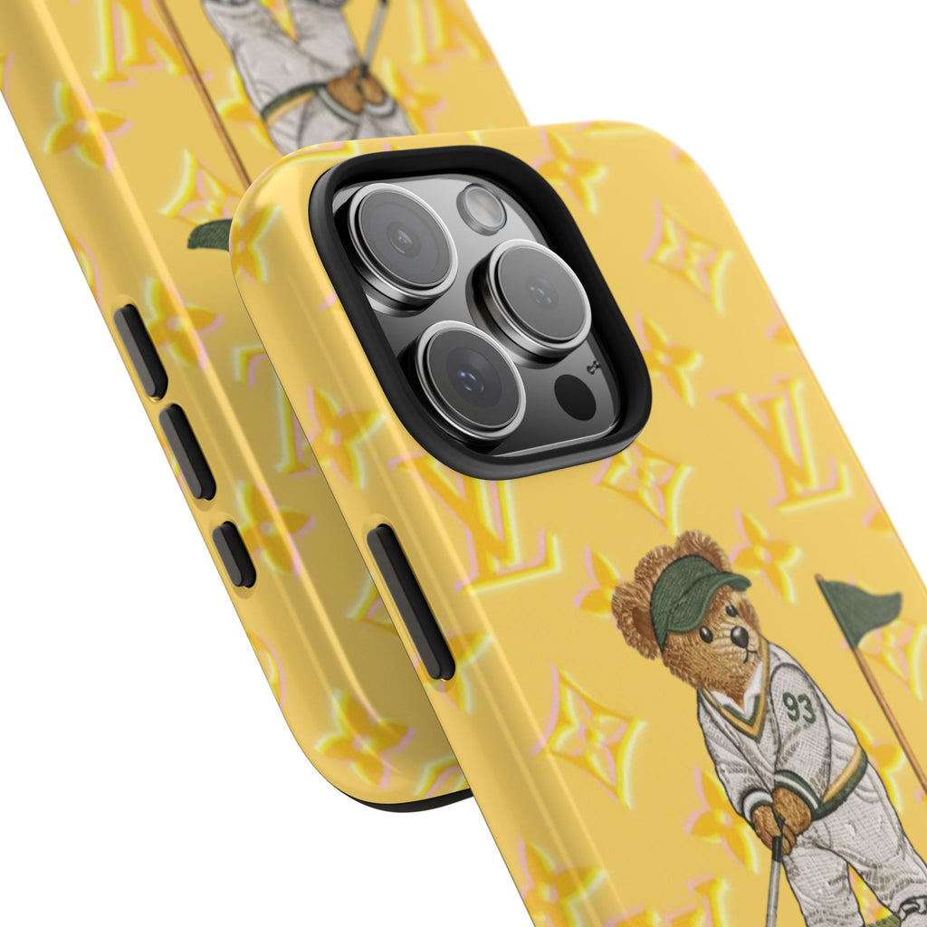 Yellow phone case close-up: teddy golfer artwork, camera cutout, LV-style pattern