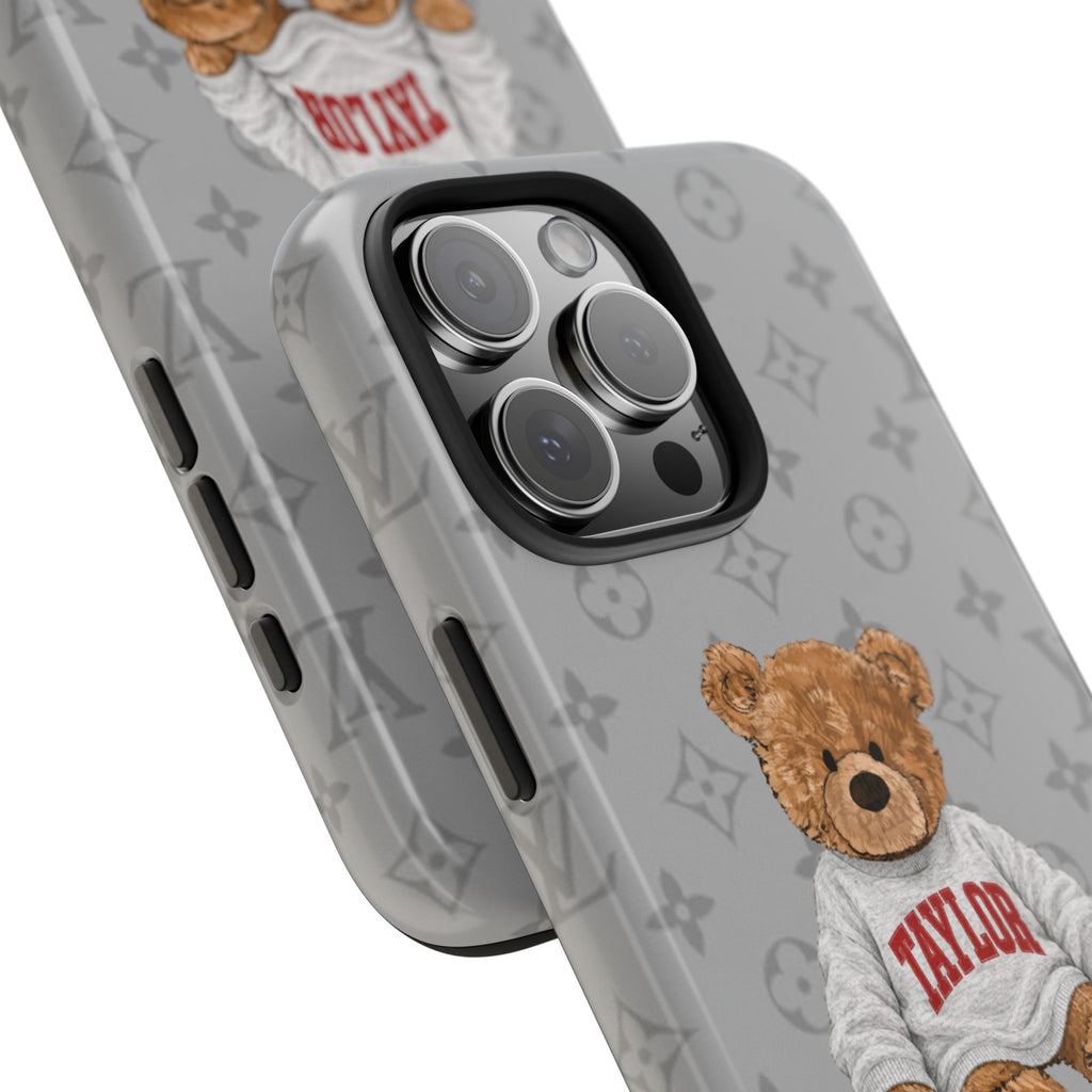Gray teddy bear phone case close-up: LV monogram, TAYLOR bear, triple camera cutout