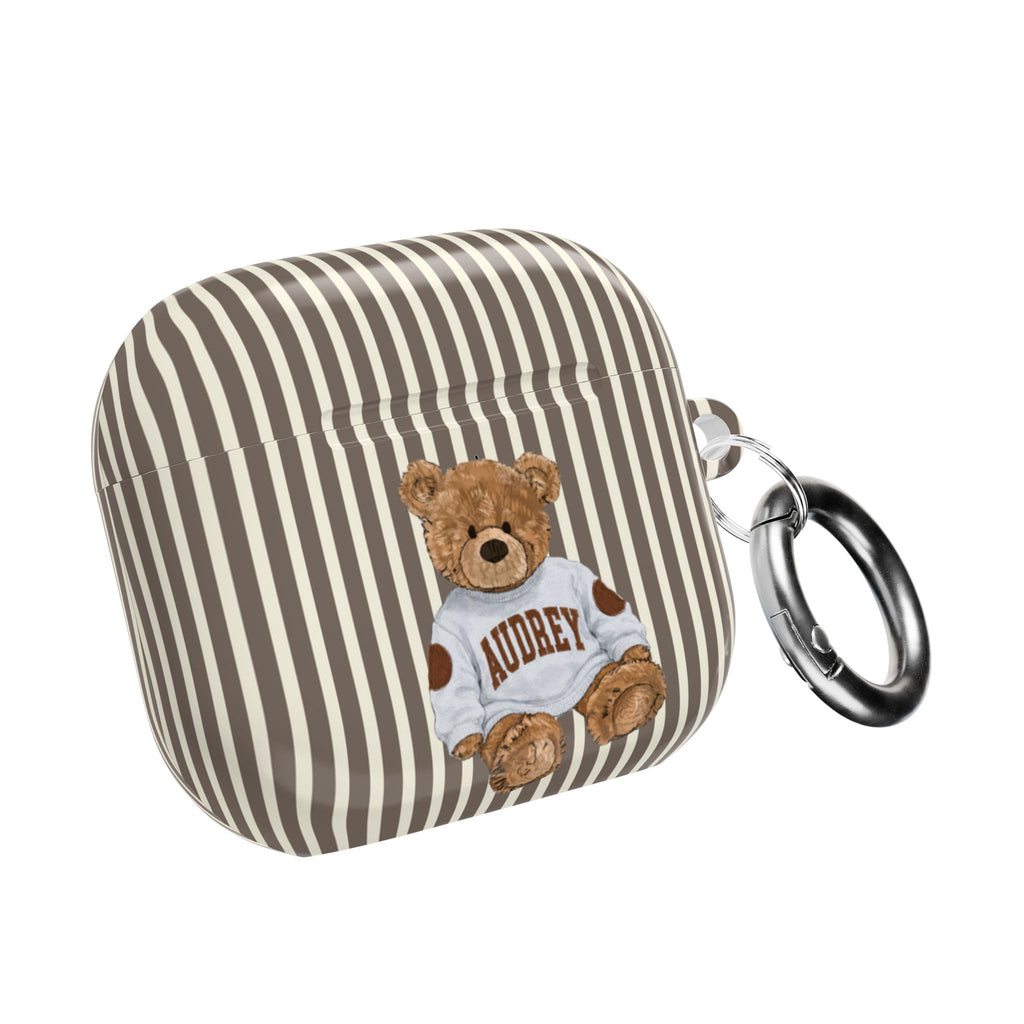 Brown-and-cream striped AirPods case with teddy bear graphic and metal keyring