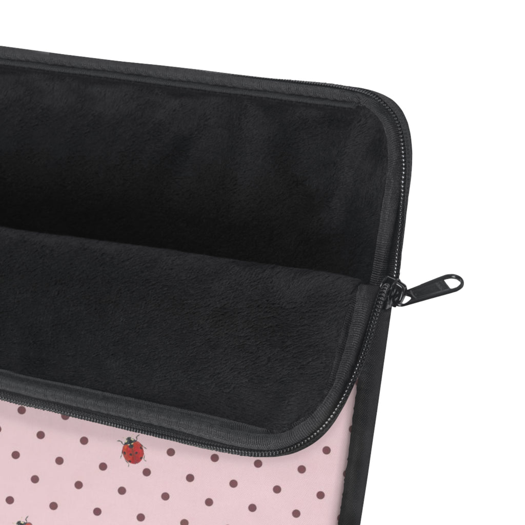Pink polka dot sleeve with ladybug print, black zipper edge and padded lining