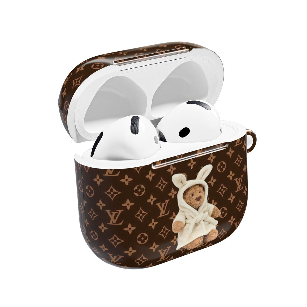 LV monogram AirPods case with open lid, showing white bear applique and earbuds