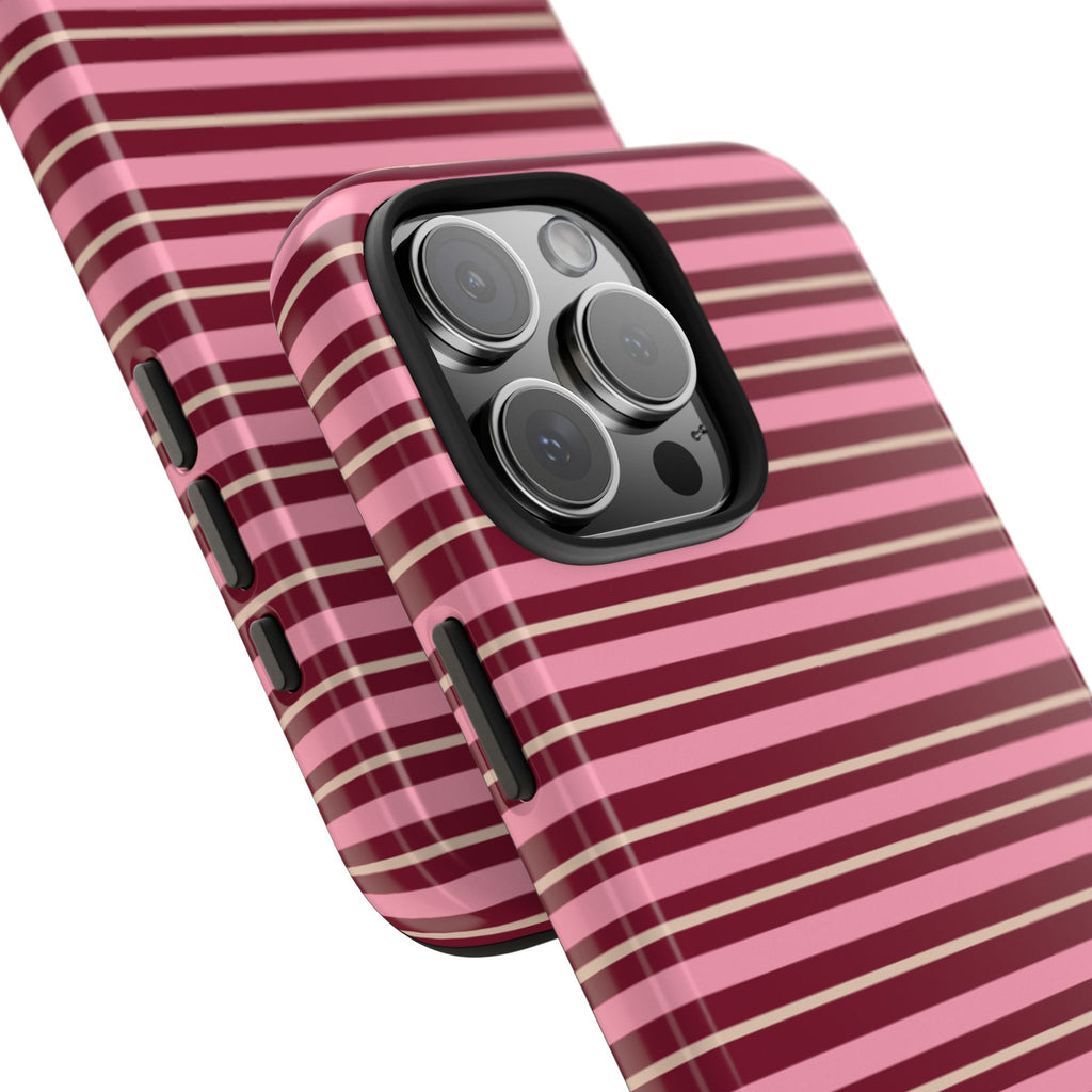 Slanted view: pink and white horizontal striped phone case with black camera cutout