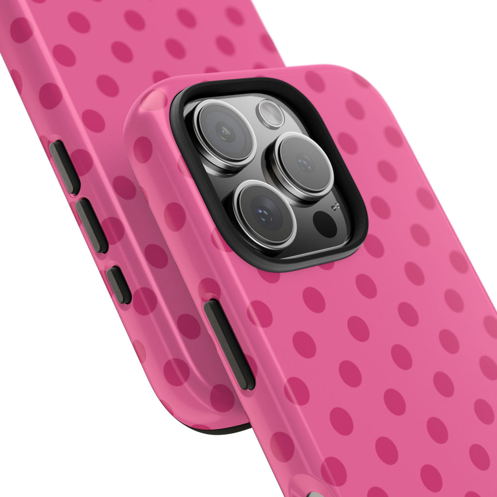 Pink polka-dot phone case close-up with side button cutouts and camera opening
