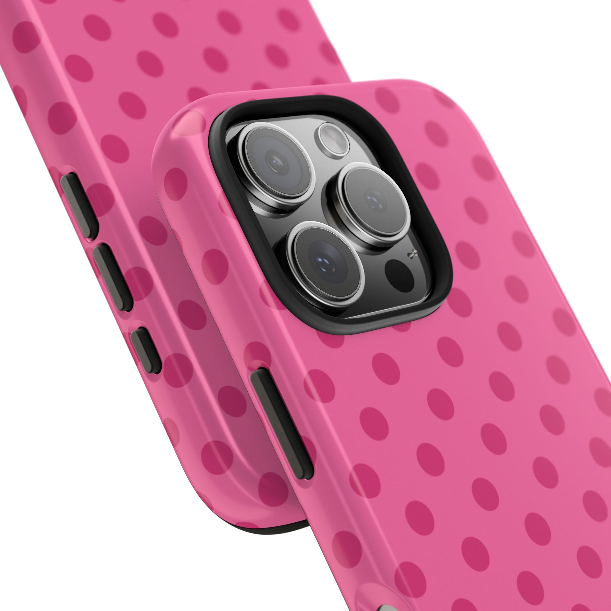 Pink polka-dot phone case close-up with side button cutouts and camera opening