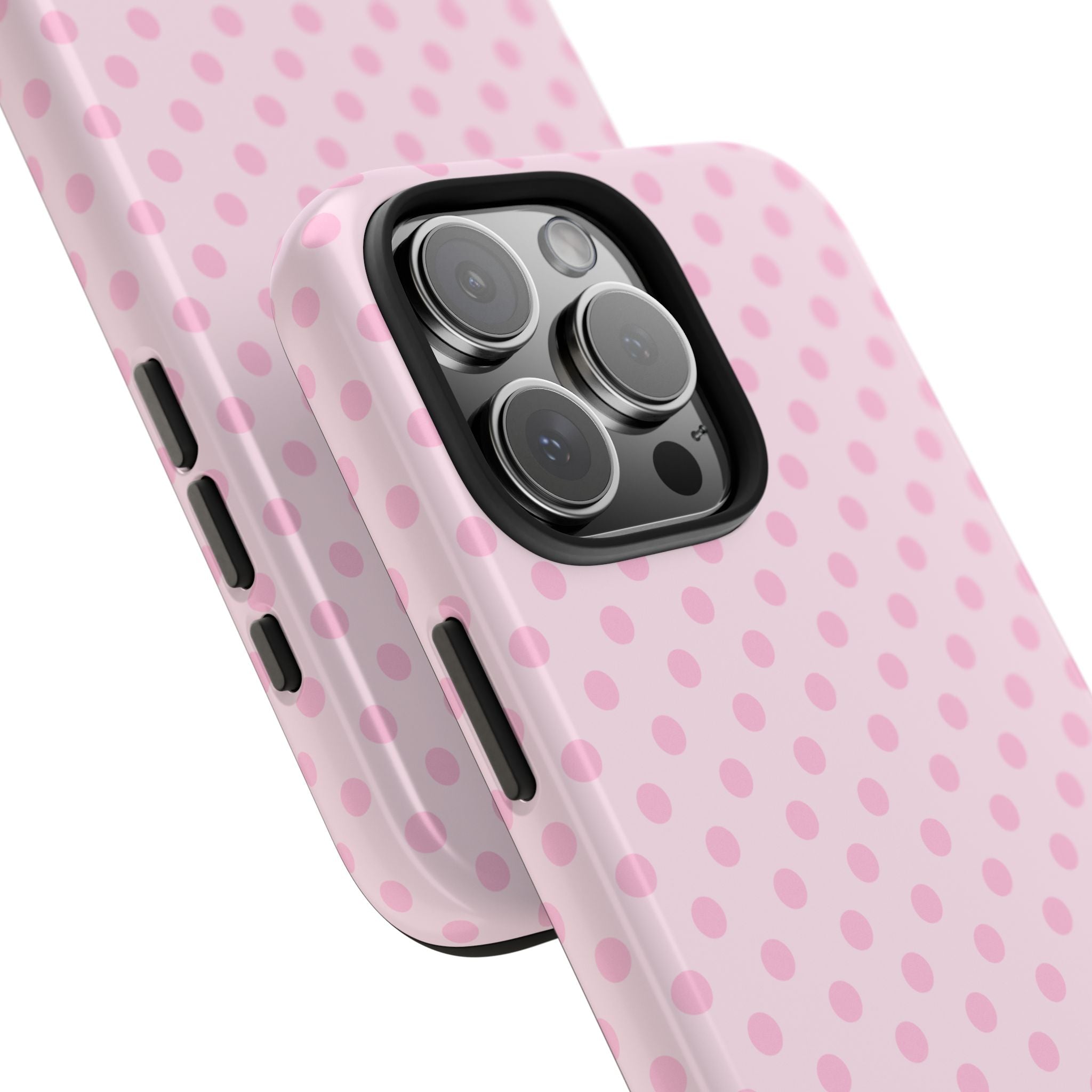 Pink polka dot phone case close-up with camera lens openings and side grips