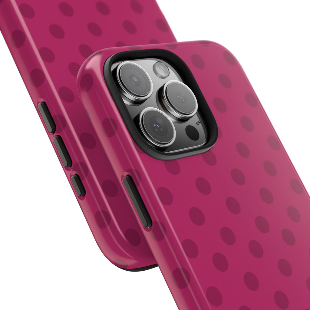 Cranberry pink phone case with dark polka dots; close view of triple camera and side cutouts