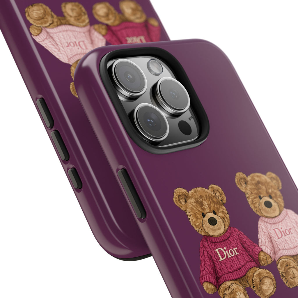 Purple phone case close-up with teddy bear in red Dior sweater near camera lenses
