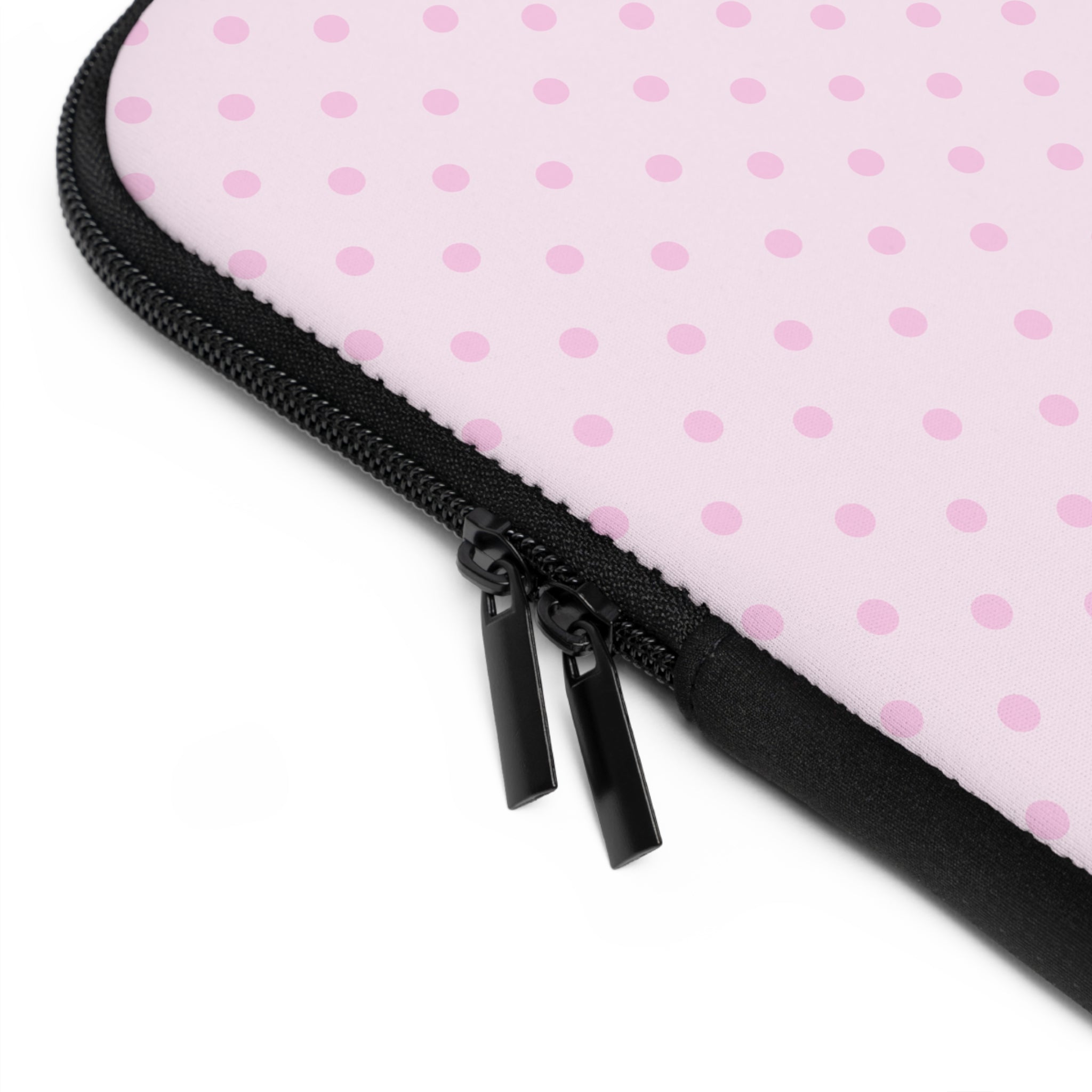 Pink polka dot neoprene sleeve corner with black zipper and stitched edge