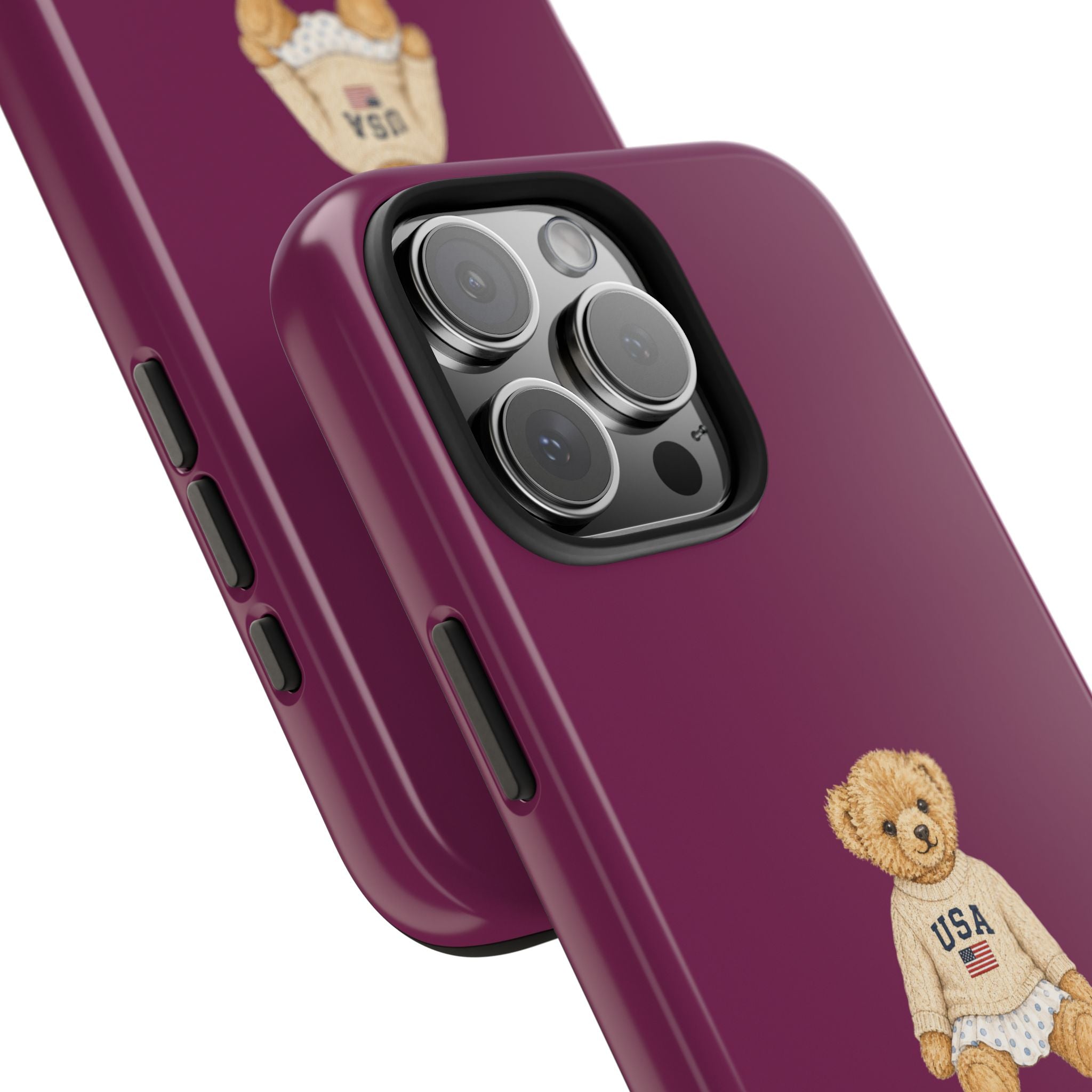 Magenta phone case close-up with teddy bear USA graphic near bottom, side buttons visible