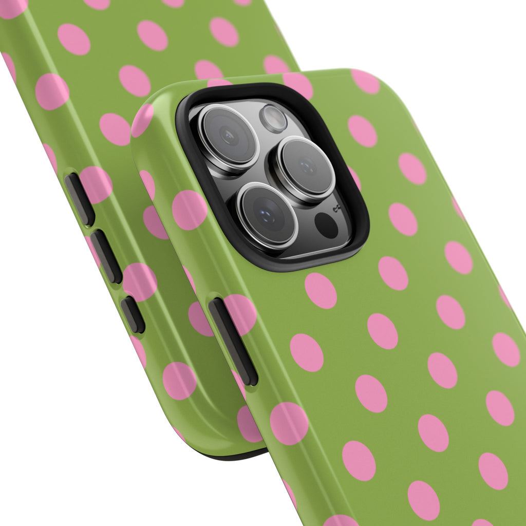 Green phone case with pink polka dots, close-up of triple camera cutout