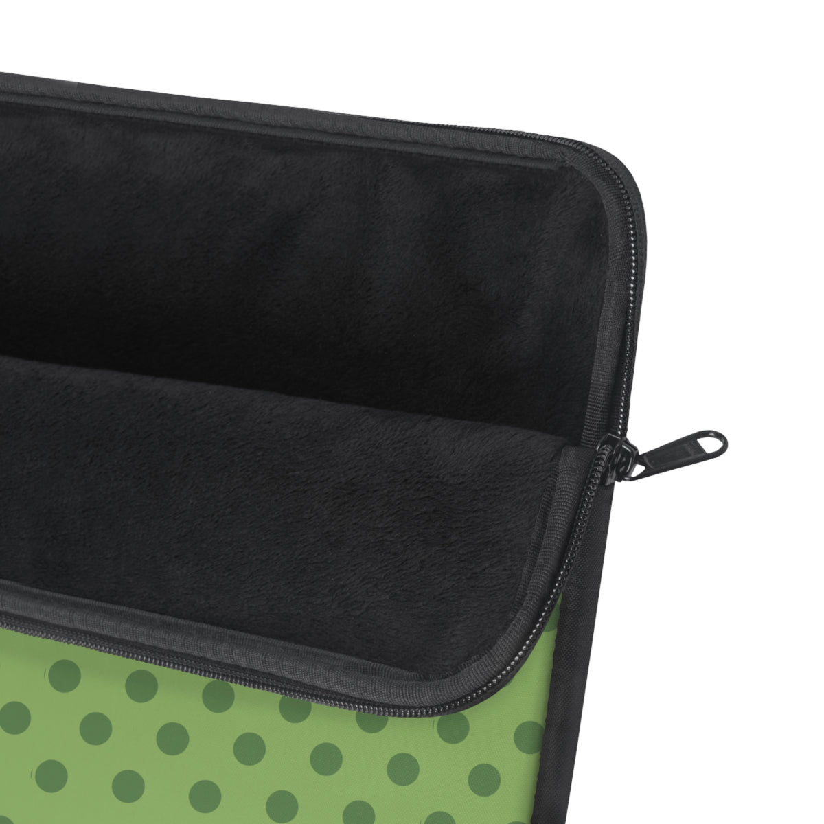 Green polka dot neoprene sleeve close-up with zipper and dark interior lining