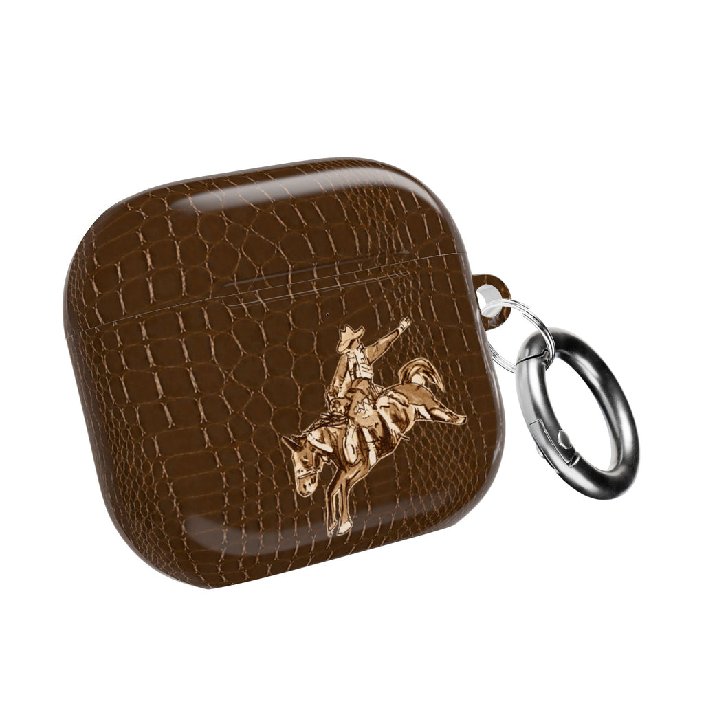 Brown croc-texture AirPod case with cowboy rider graphic and metal key ring loop.