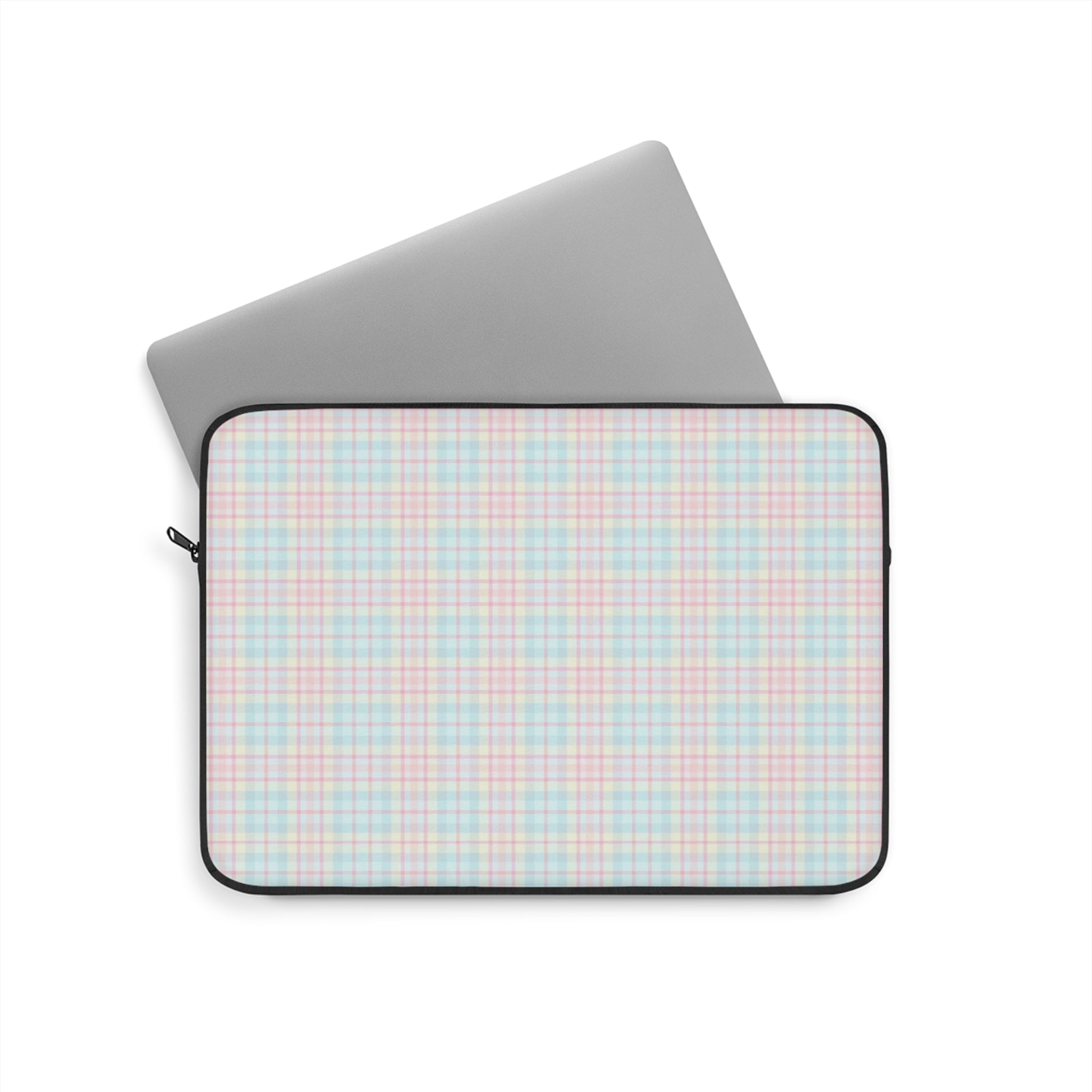 Pastel plaid device sleeve with black zipper and trim; tablet partially visible.