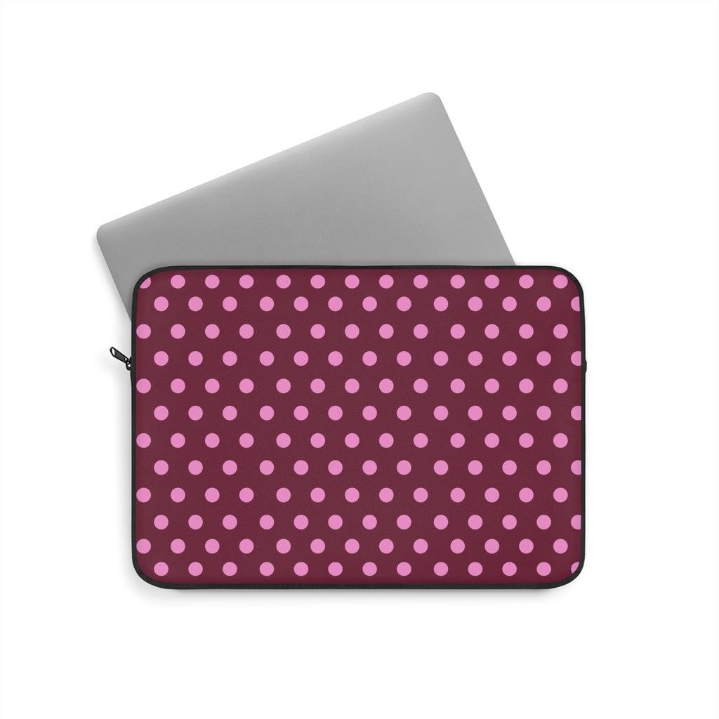 Raspberry polka dot neoprene sleeve with black trim and zip closure