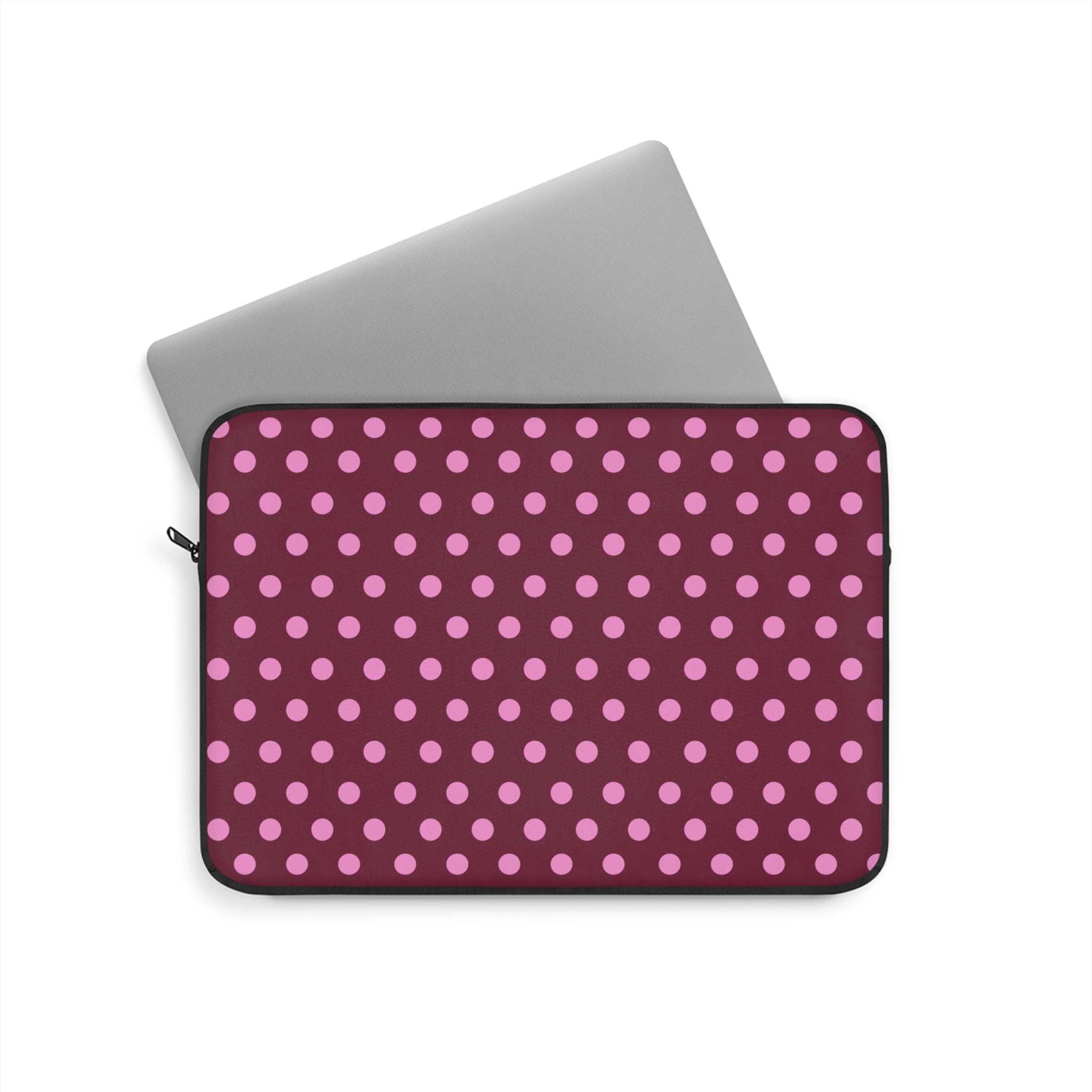 Raspberry polka dot neoprene sleeve with black trim and zip closure