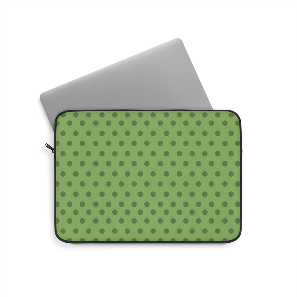 Green polka dot neoprene sleeve with black zipper trim, holding a gray tablet