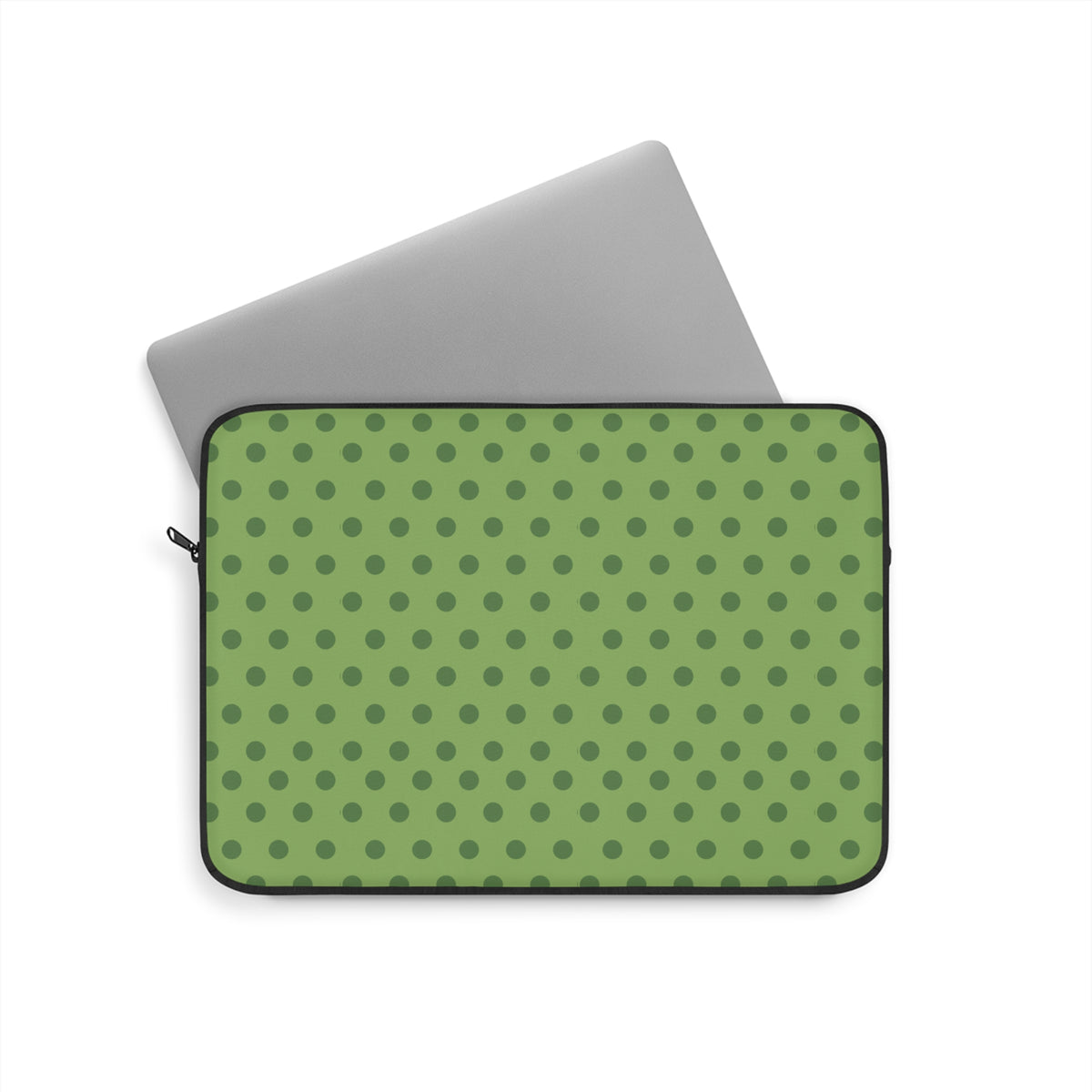 Green polka dot neoprene sleeve with black zipper trim, holding a gray tablet