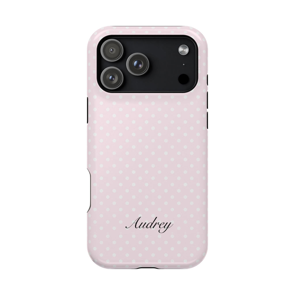 Pink polka dot phone case with cursive 'Audrey' and raised camera cutouts