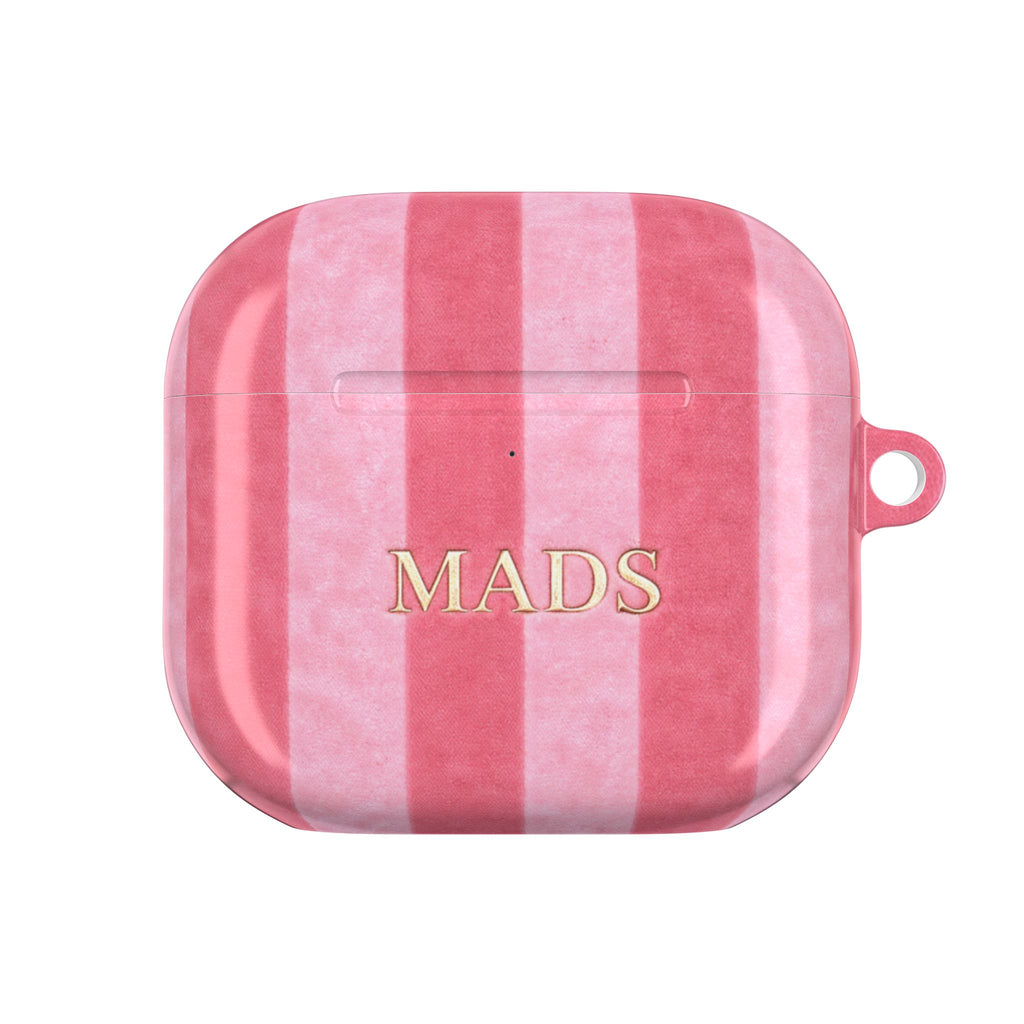 Pink velvet AirPods case with vertical plaid stripes and “MADS” print, front view.