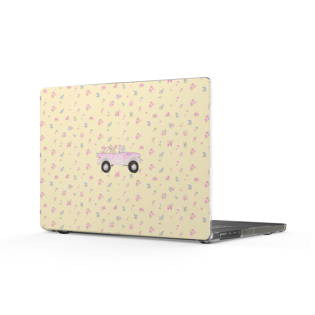 Laptop cover with yellow ditsy floral pattern and pink vintage Bronco graphic