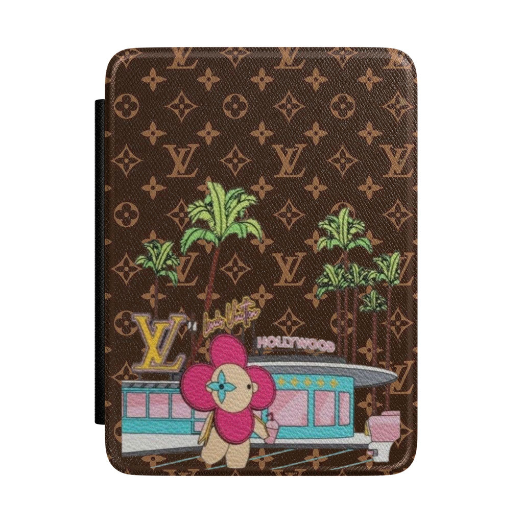 Hardcover Kindle case with brown monogram pattern and colorful character illustration
