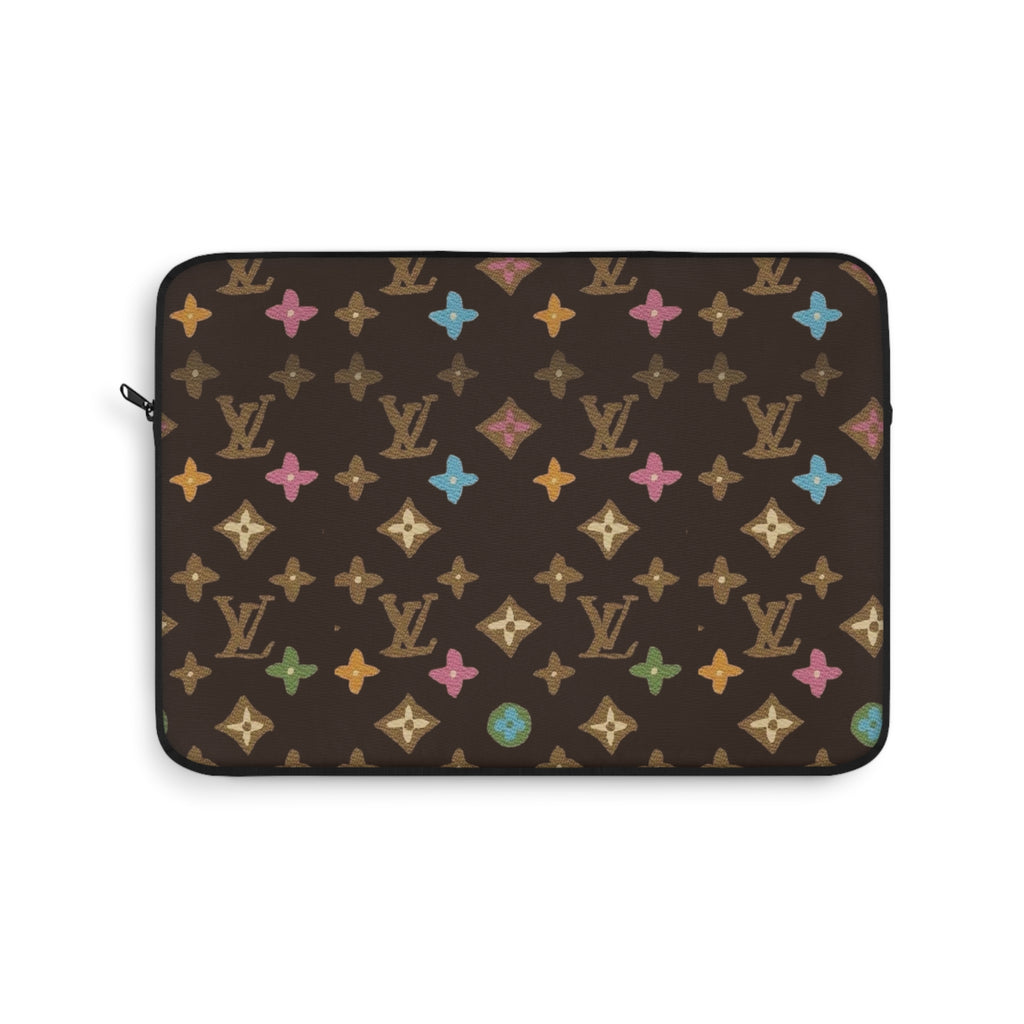 Brown zippered laptop sleeve with multicolor star and monogram pattern, rounded corners.