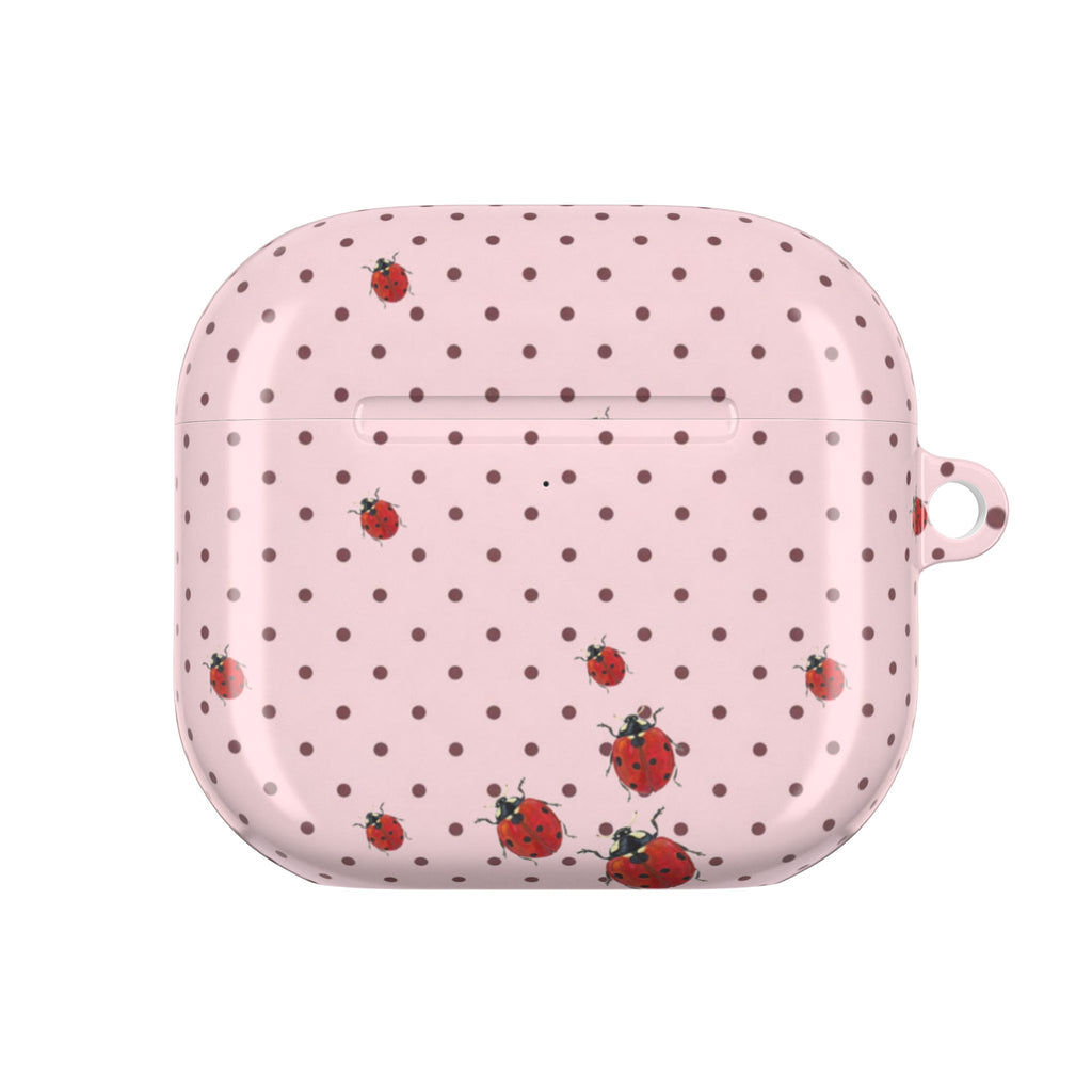 Pink polka dot AirPods case with ladybug print and visible charging slot