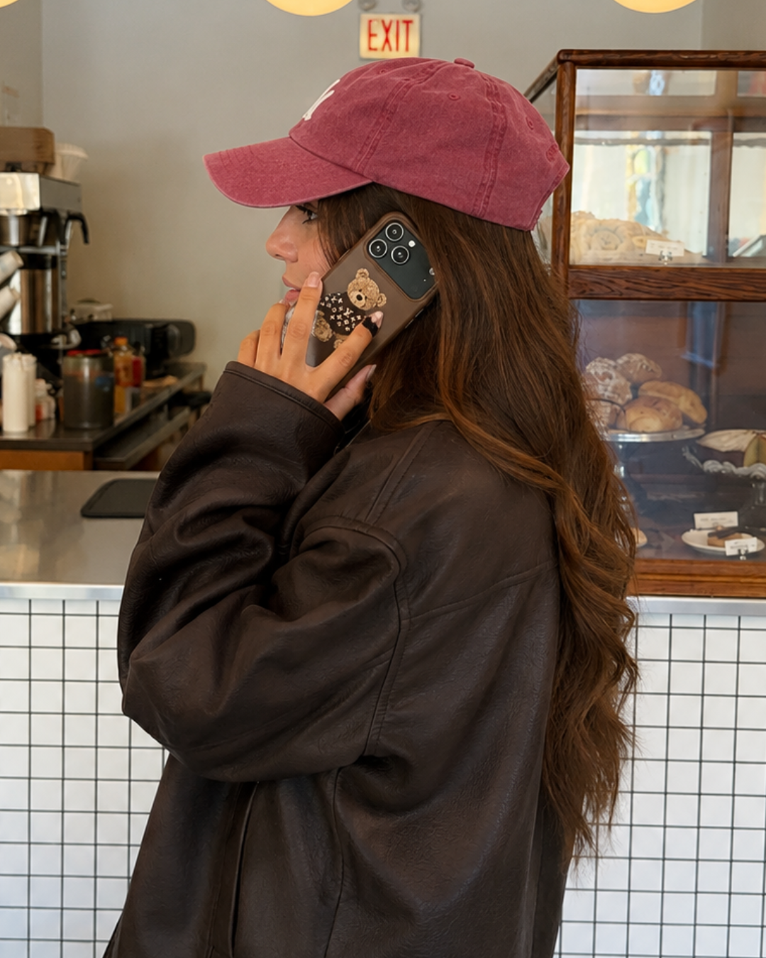 Brown teddy bear sweater phone case with LV-style bear graphic on phone back