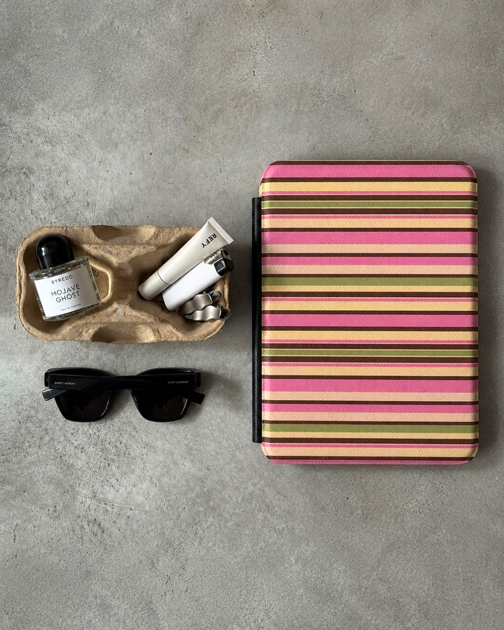 Hardcover Kindle case with pink, yellow, and olive horizontal stripes