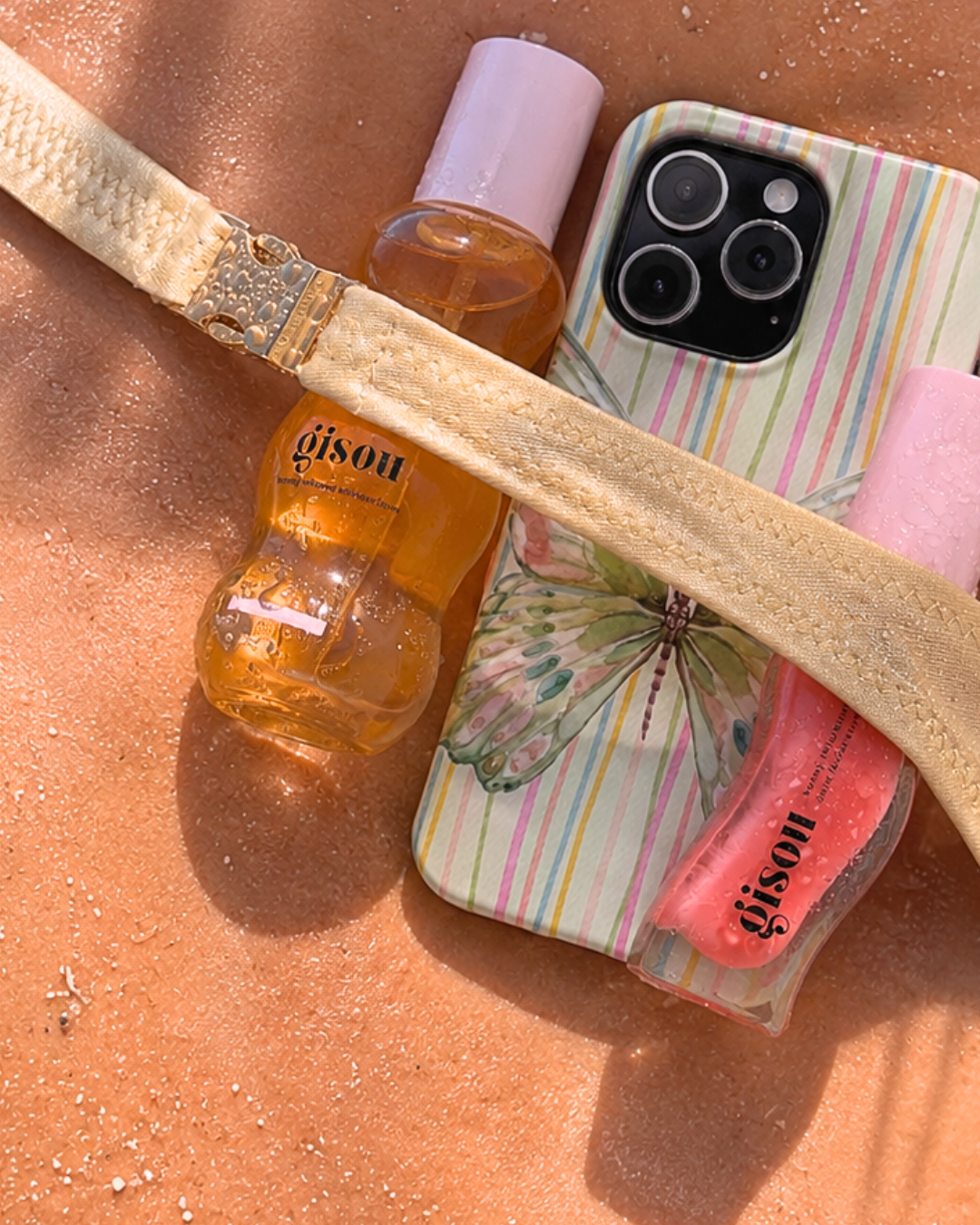 Phone case with butterfly-striped design and camera cutouts, glossy clear back