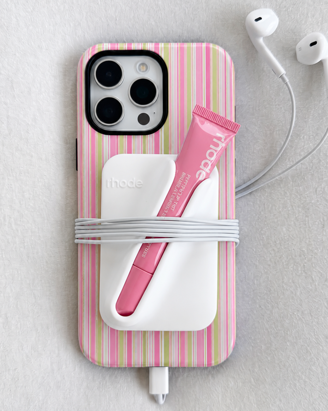 Phone case with pink and white vertical stripes and raised camera cutout