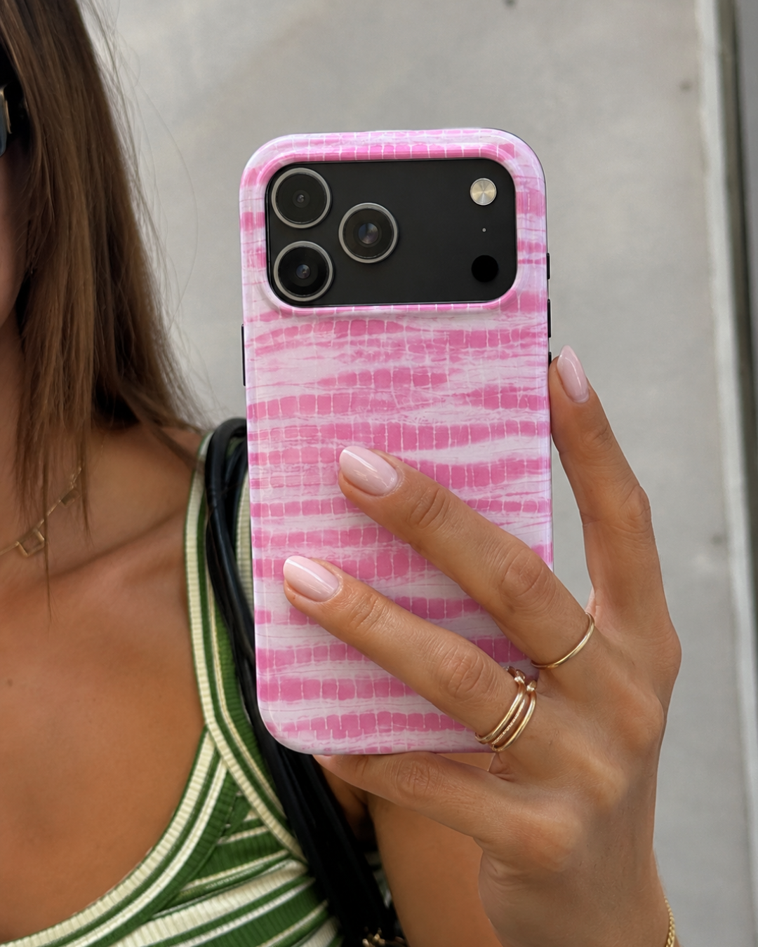 Baby pink coastal wash phone case held in hand, showing camera cutouts and edges