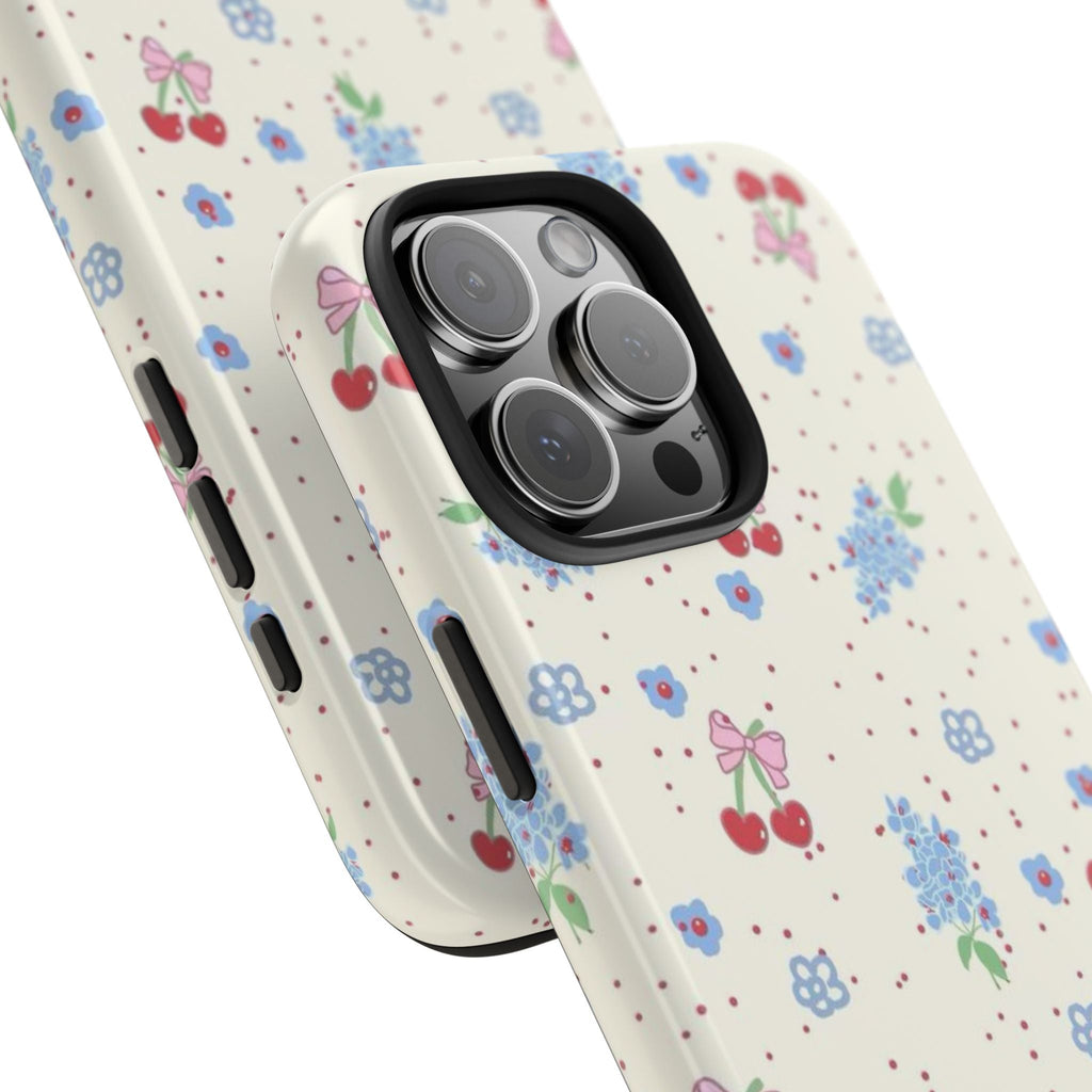 Floral phone case detail view, cream with blue flowers; side buttons and camera openings