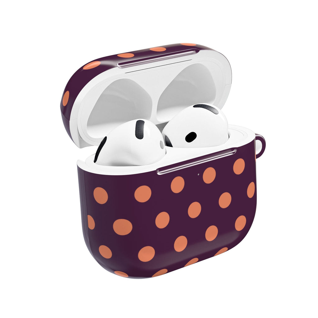 Aubergine AirPods case with orange polka dots, open lid showing earbuds