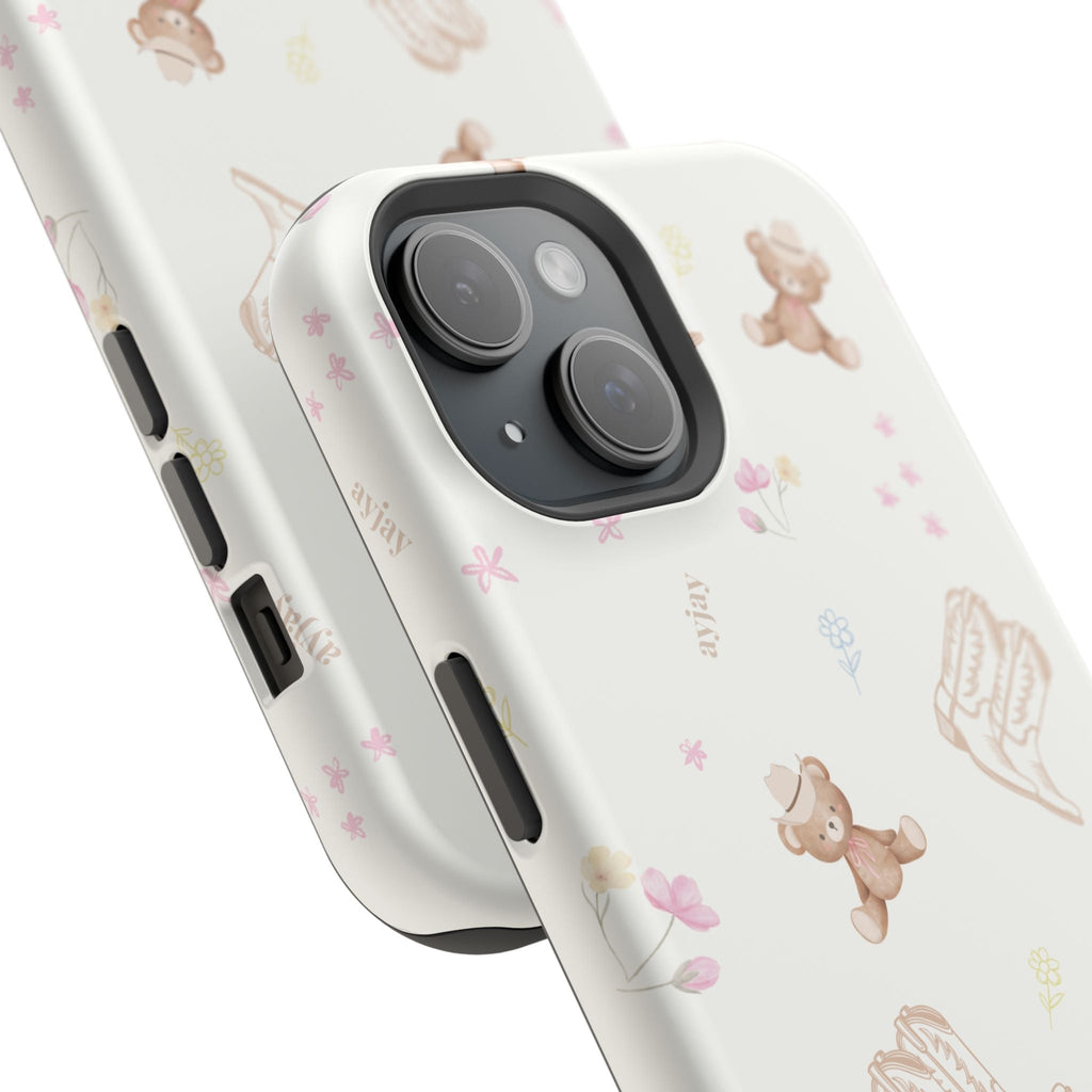 Cream phone case with teddy bear-and-boot illustrations and floral accents; side buttons.