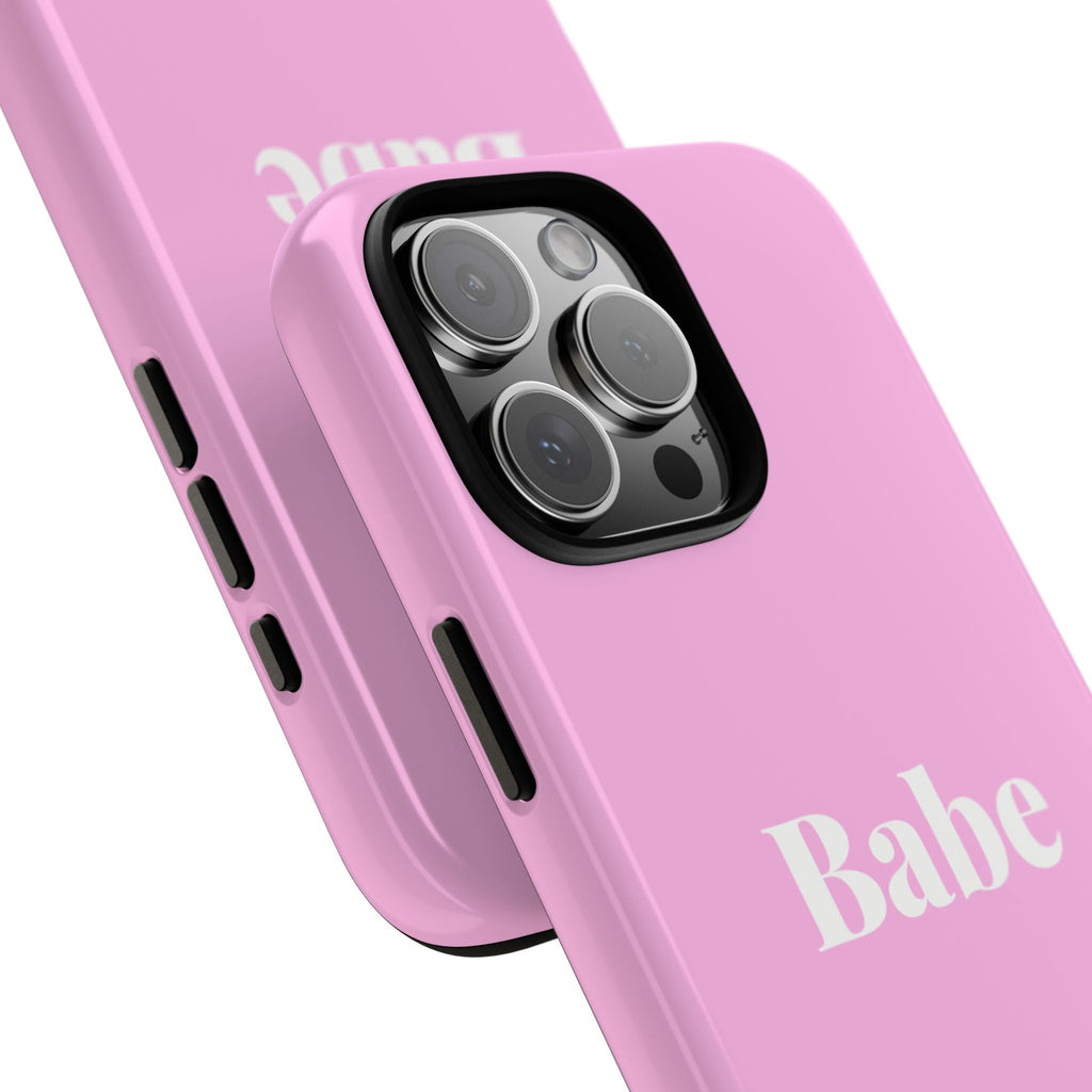 Close-up of pink “Babe” phone case with triple-lens camera cutout and raised edges