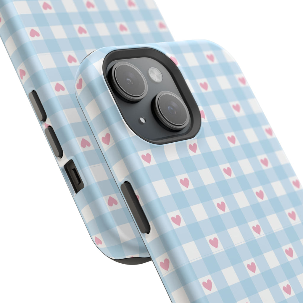 Angled view of baby blue gingham phone case with pink hearts, camera and buttons
