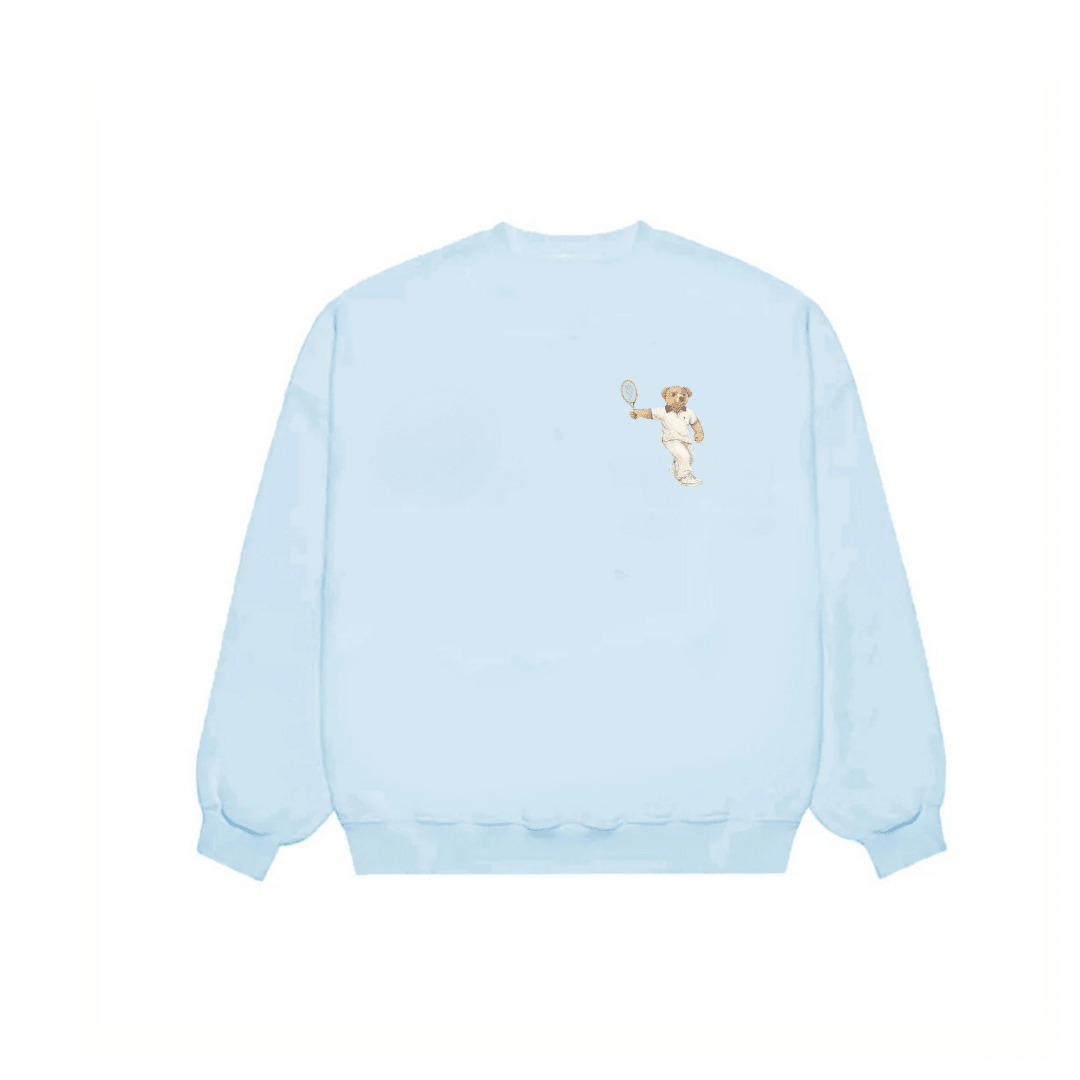 Baby blue crewneck sweatshirt with small teddy bear tennis graphic on chest