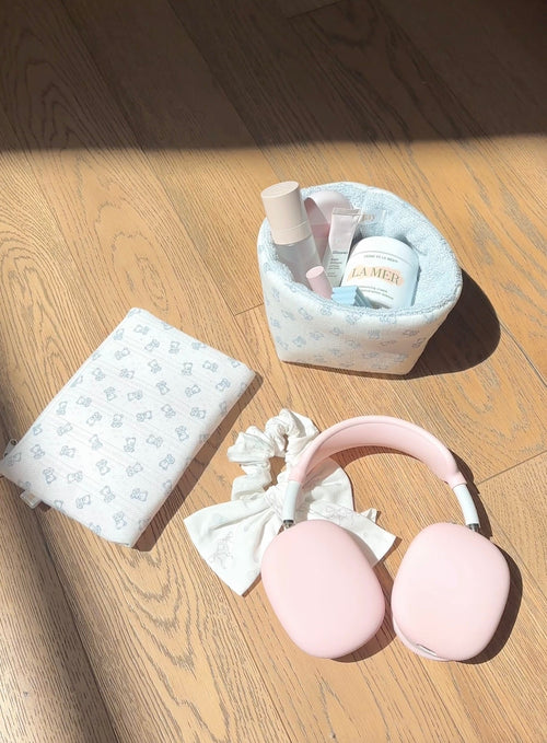 Baby blue teddy bear organizer pouch with zip top, folded blanket and bottles